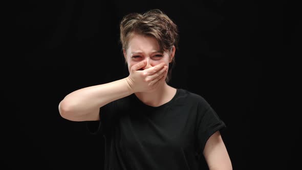Frustrated Oppressed Woman Closing Mouth with Hand Crying and Looking at Camera alt