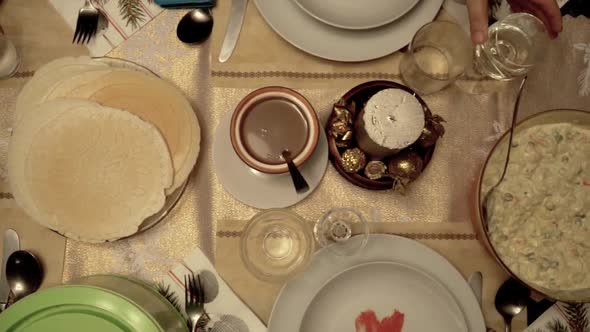 Overhead left slow motion slide over richly decorated Christmas dinner table alt