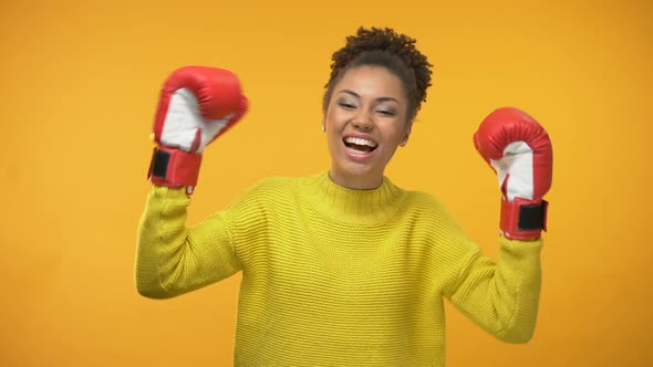Happy Afro-American Woman in Boxing Gloves Celebrating Success, Champion alt
