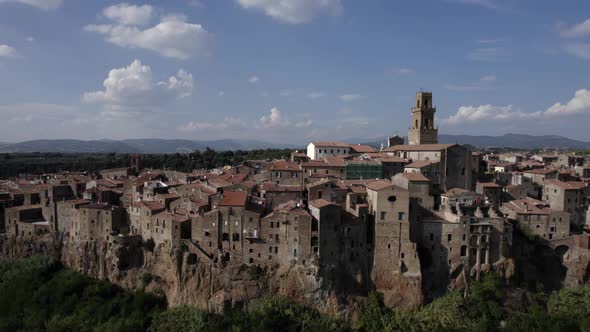 -SHOT: slider, side to birds eye-DESCRIPTION: drone video over the side of Pitigliano, Italy-HOUR. alt