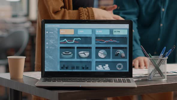 Close Up of Modern Laptop with Rate Charts on Display alt