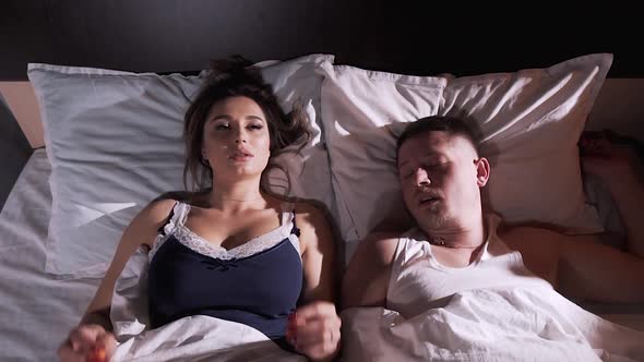 Girl in Bed with her Husband cannot Fall Asleep