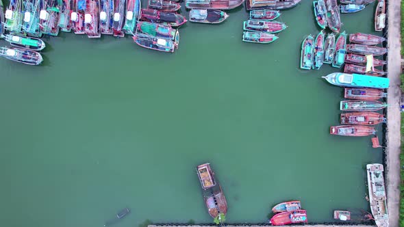 Top view of fisherman boats in harbor with wooden fish boats in fish market Phuket Thailand alt