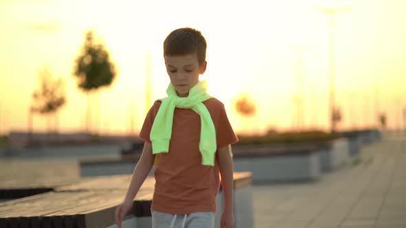 Trendy Child Walking in a Sunset City