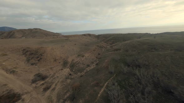 Mountain Bare Top with Brown Rocky Cliffs and Dense Thickets High Speed Dive alt