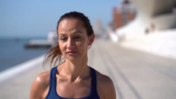 Beautiful Young Sportswoman Jogging at Riverside alt