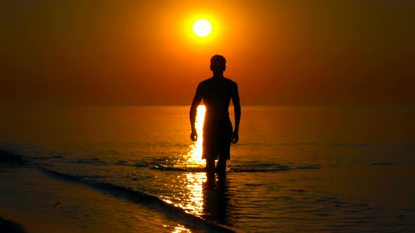 young man on the background of the sea sunset