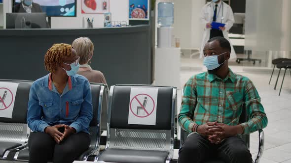 African American Patients with Face Mask Talking in Waiting Area alt