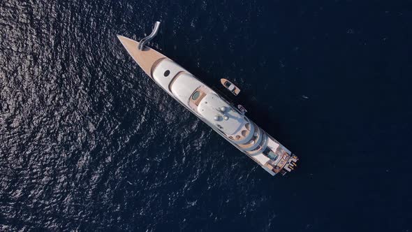 Aerial view of large super yacht and small boat. Luxury life on a super yacht.