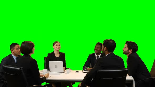 Businesspeople interacting with each other during meeting alt