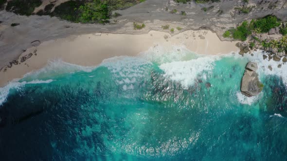 Top Down Aerial View of Azure Blue Water Ocean Waves Crashing on Wild Beach alt