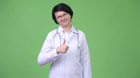 Beautiful Woman Doctor with Short Hair Giving Thumbs Up alt