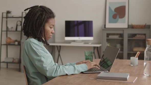 Female African Student Studying at Home Using Computer alt