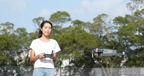 Woman control fly drone alt