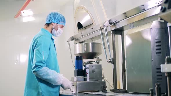 Pharmacology Worker is Replacing Meds on the Conveyor alt