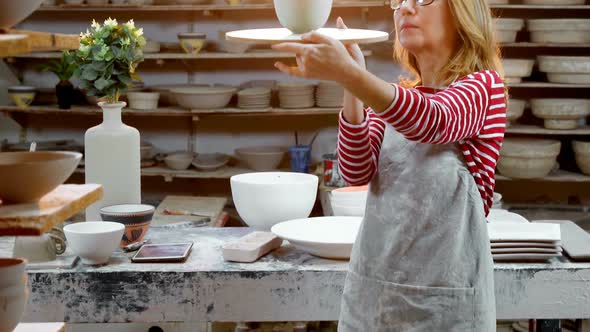 Female potter holding bowl 4k alt