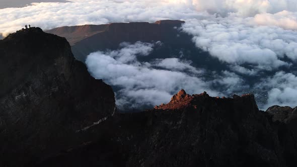 Drone footage of the summit of the Piton des Neiges while the sun rises on the Reunion island. alt