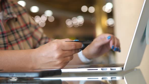 Female Hands of Cardholder Holding Credit Card Making e Bank Online Payment