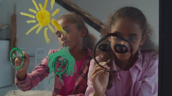 Cute Preadolescent Sisters Painting Family on Glass, Stock Footage