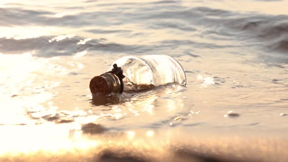 Message in the Bottle Against the Sun Setting Down alt