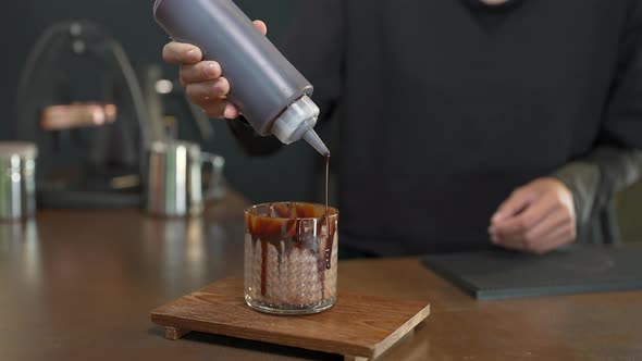 4K Asian woman barista make iced chocolate with froth milk serving to customer