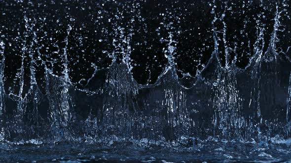Super Slow Motion Shot of Linear Water Splash at 1000Fps on Black Background alt