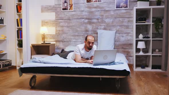 Watching a Movie Late at Night on Laptop alt