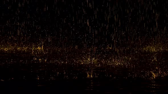 Large Yellow Raindrops Drum on the Water and Bounce To the Sides Creating Splashes. Dark Studio with alt