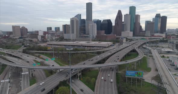 Aerial view of traffic on freeway near downtown Houston on a cloudy day during sunset. This video wa alt