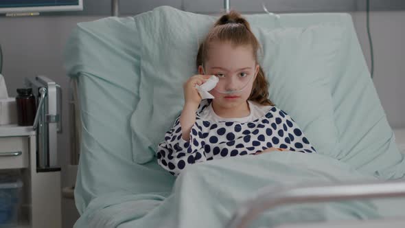 Portrait of Sick Vulnerable Alone Little Child Looking Into Camera While Crying alt