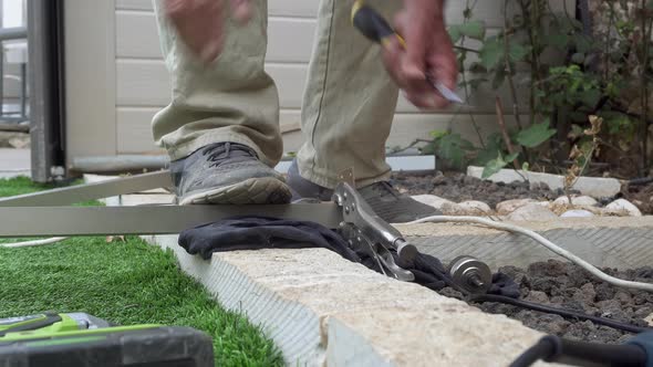 senior man hands drilling a screw outdoors house repair garden