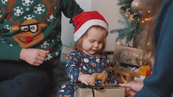 Happy Family Having Fun and Playing Together Near Christmas Tree at Home. alt