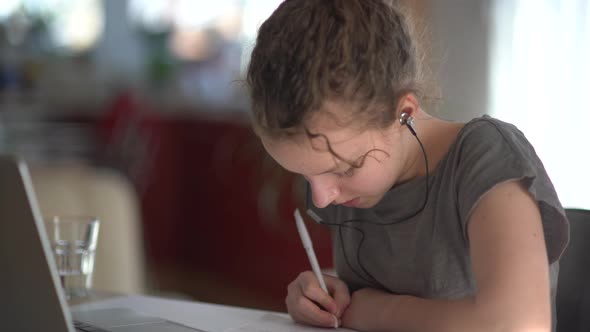 Children Education and Distant Learning Concept Teenage Student Girl in Headphones with Laptop