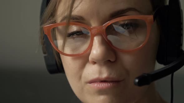 Closeup Portrait of Beautiful Serious Woman with Headphones and Microphone in Glasses Reflecting alt