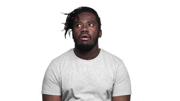 Portrait of Bored Dark Skinned Guy in Casual Tshirt with Afro Pigtails Rolling His Eyes in alt