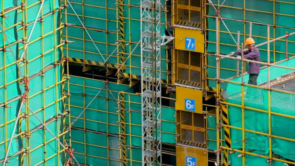 Construction Workers on the Rooftop of a Residential Building Under Construction