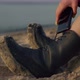 Woman Legs in Boots Sitting on Sandy Beach - VideoHive Item for Sale