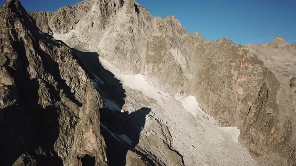 rocky summits in the swiss alps, blue sky. aerial drone view alt