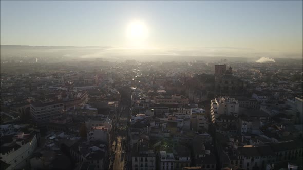 Descending sunset drone shot over Granada, view of Granada Cathedral