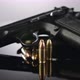 Gun Control. 9mm handgun with bullets rotating on a reflective surface - VideoHive Item for Sale