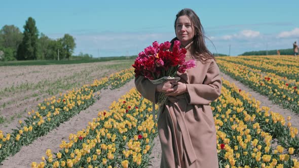 Woman walks with bouquet of tulips