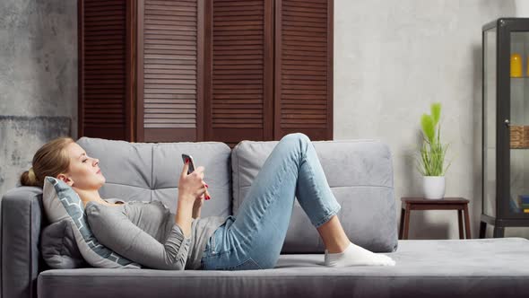 Young woman works with documents using a laptop at home. alt