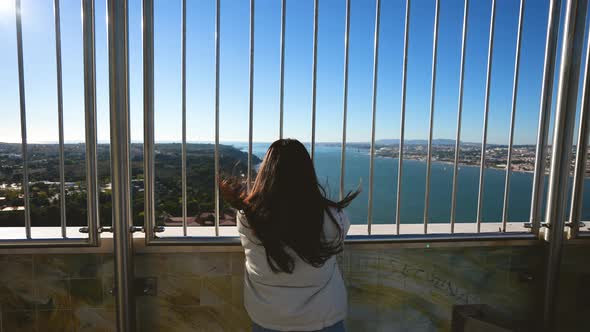 Female Tourist Standing at Cristo Rei Monument Observation Deck