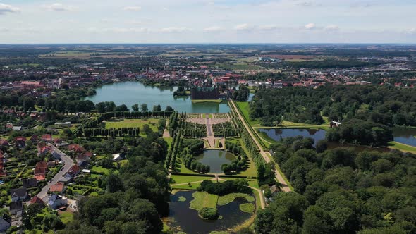 Aerial View Of Frederiksborg Castle, Park, Lake, And Garden In Hillerod, Denmark. - pullback alt