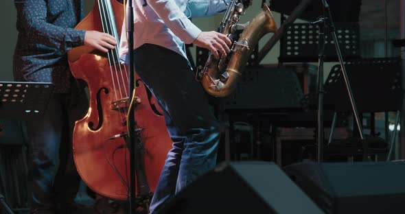 Caucasian Men at a Concert Playing Jazz and Blues on Saxophone and Contrabass