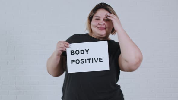 Concept Body Positivity an Overweight Smiling Woman Dancing and Holds a Sign with the Inscription alt