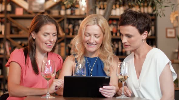 Women with Tablet Pc at Bar Wine or Restaurant  alt