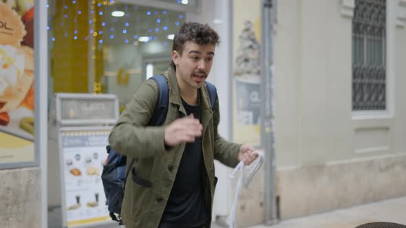 Street Magician Showing Magic Trick From Rope Outside the Cafe in the Street alt