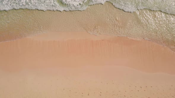 Top View of Sandy Beach with Foot Prints Closeup
