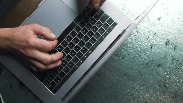 Elderly Man Typing on Laptop alt